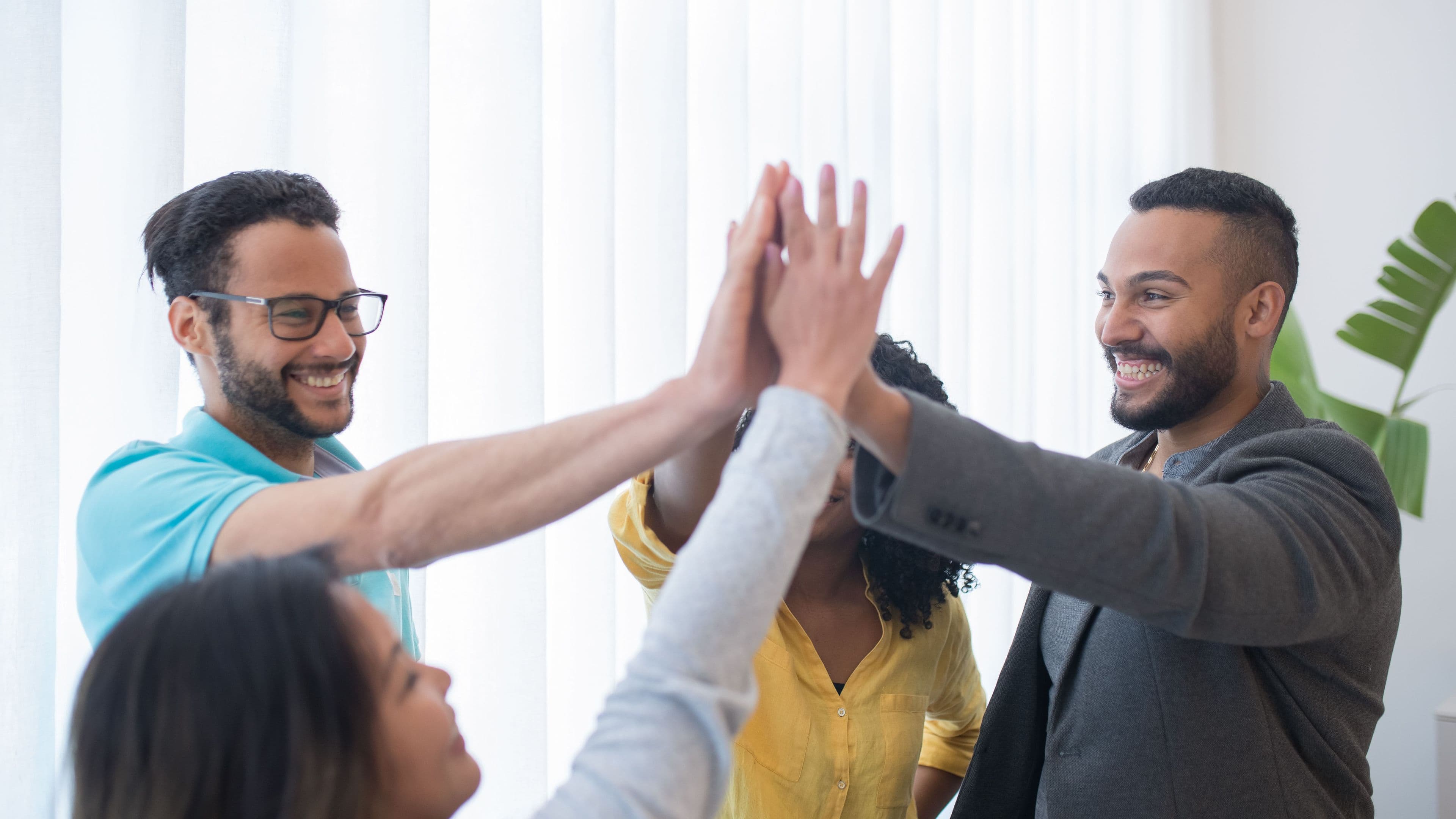 Colleagues celebrating with a high five in the office